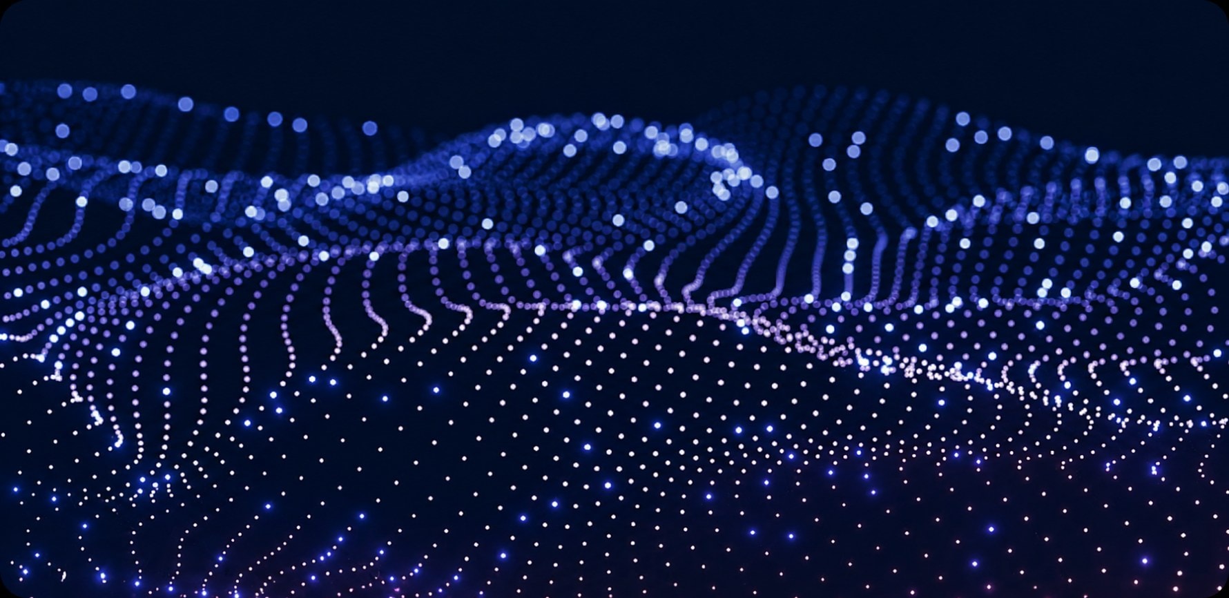 Flowing wave of glowing blue particle dots forming a 3D mesh surface on a dark navy background